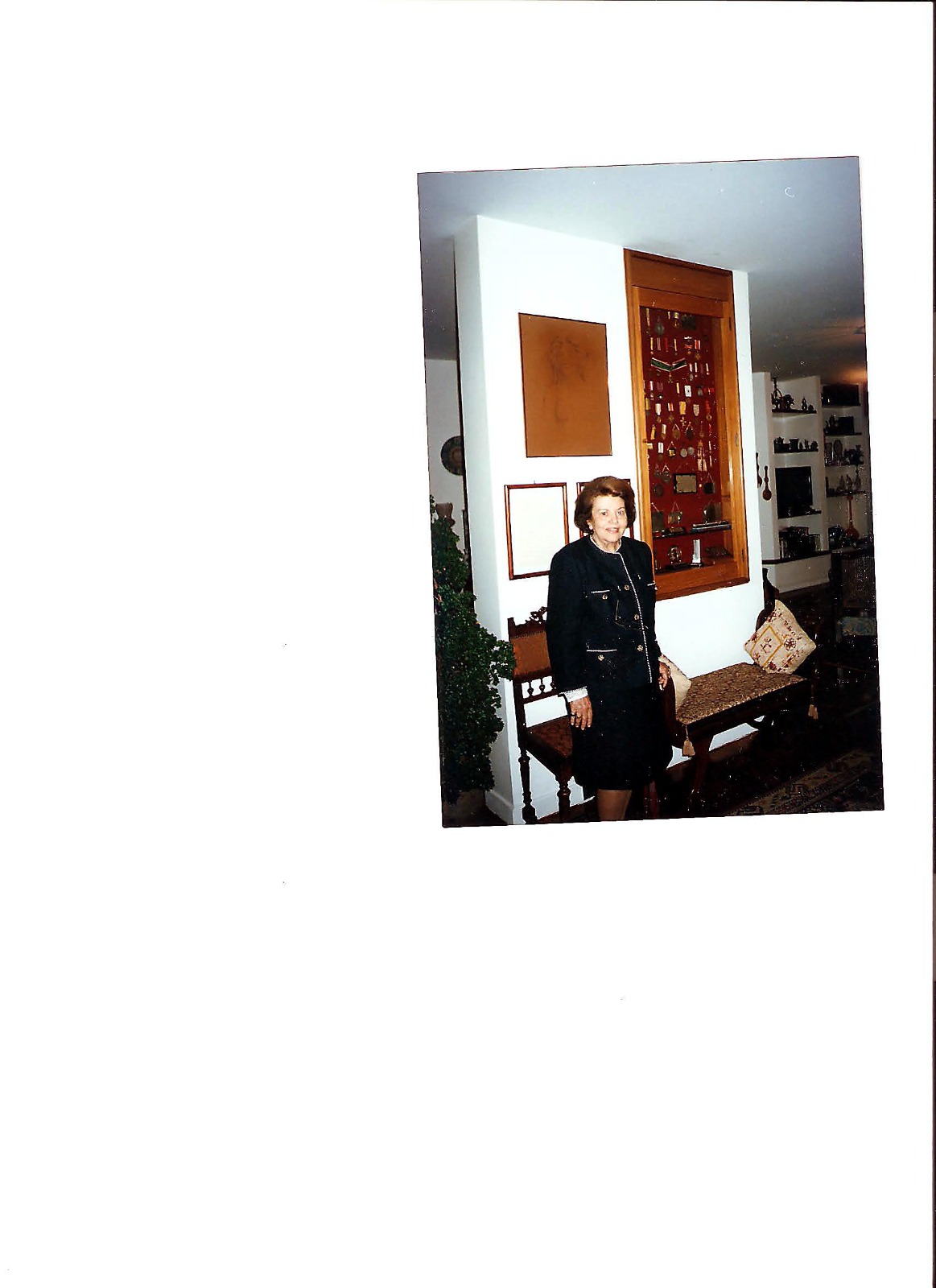 Dulce Salles Cunha Braga, in her room with a display case of medals